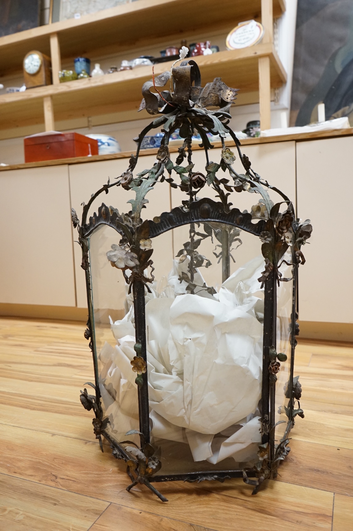 A large French painted wrought iron decorative floral and swagged hexagonal hall lantern, 84cm high